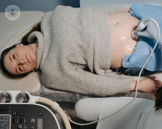 A woman having a transabdominal gynaecological ultrasound.