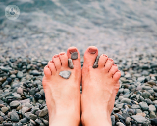 Someone resting their feet after minimally invasive bunion surgery