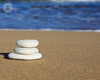 An image of stones stacked on the beach