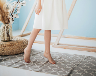 A young girl toe walking.