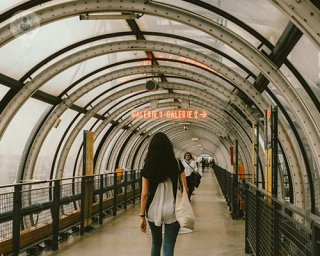 Woman at a train station, a shot of her from  behind