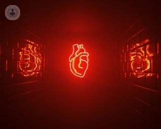 A neon light heart floating in a room with reflective walls