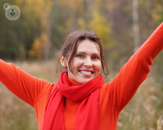 A smiling woman who has an enhanced way of life