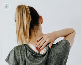 A young woman with neck pain.