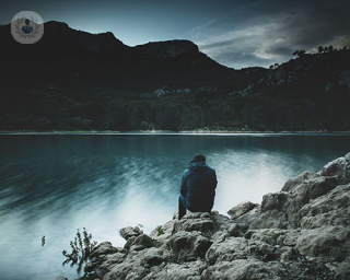 A man looking over a lake