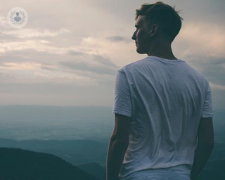 Man on a mountain thinking about penile conditions