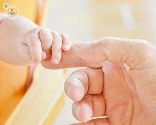 IVF baby holding parent´s hand 