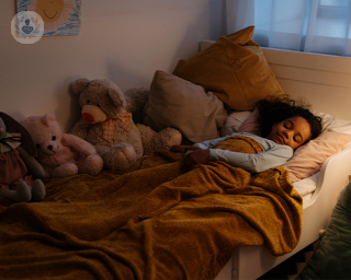 A child sleeps, not aware that they are bedwetting