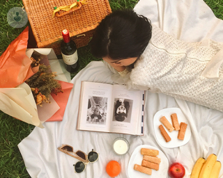 Woman enjoying a picnic with healthy food