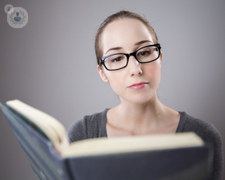 A woman reading a book. 