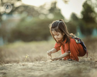 A litle girl playing outside