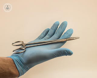 An image of a surgeon holding an instrument 