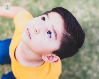 A young child looking up to the sky.