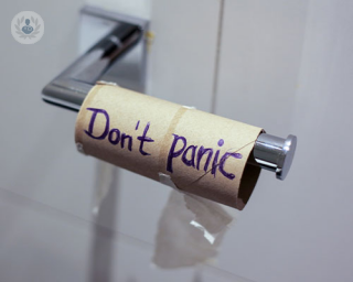 the end of a toilet roll with DON'T PANIC written on the cardboard