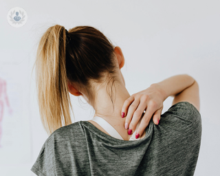 Woman experiencing pain in the shoulder