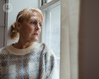 Woman with thinking about the signs of ovarian cancer.