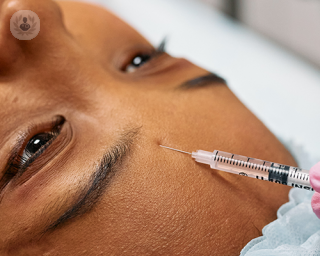 A young woman receiving a skin injection treatment