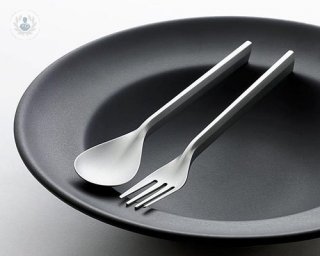 empty plate and stainless steel fork and spoon