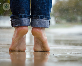 Feet tiptoeing in the rain