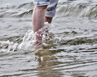 person in the sea showing legs