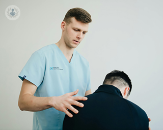 An image of a physiotherapist helping a patient