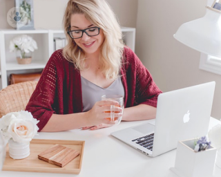 Woman happy looking at her laptop