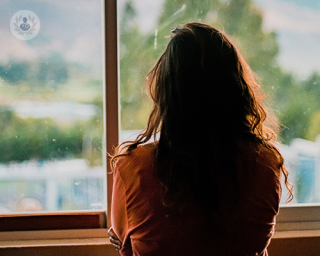 A young woman staring out of the window