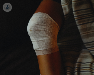 A person's knee in a bandage