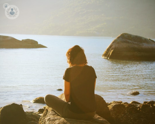 Woman overlooking the sea while thinking about hormones preventing weight loss