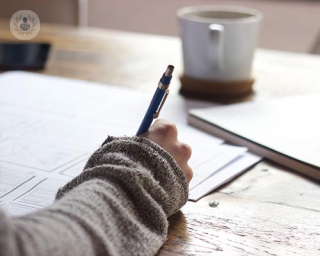 A woman writing at her desk