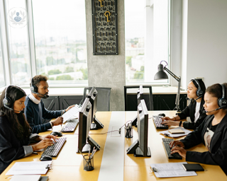 A group of four teleoperators sat at their desks in an office.