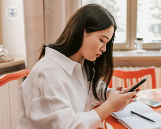 A young woman texting on her phone