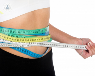 woman with measuring tape around waist