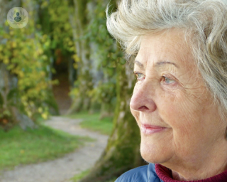 Older woman outside thinking and looking away from the camera