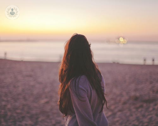 woman on beach thinking about PCOS