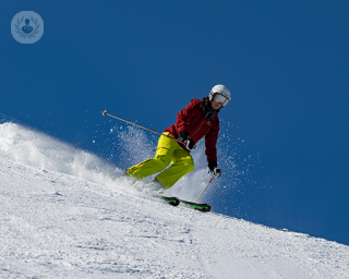 A person skiing down the slopes.