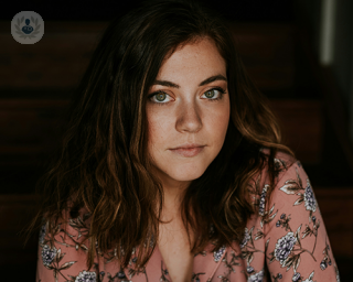 A young woman looking on pensatively