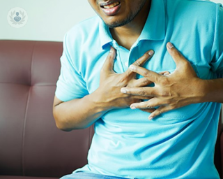 A man clutching his chest in pain