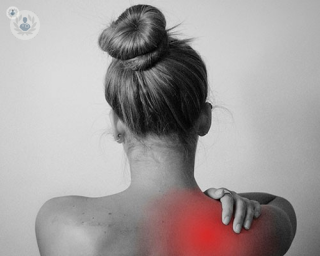 Woman experiencing pain in the shoulder