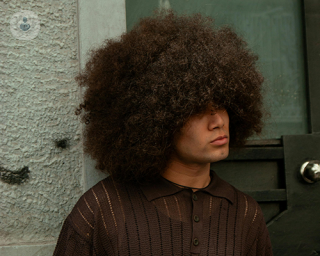 A young man with Afro/textured hair.