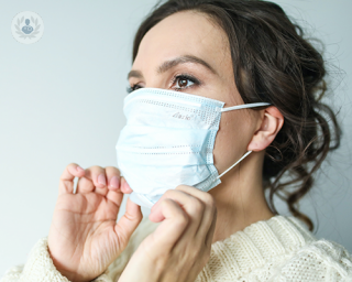 A woman wearing a white face mask