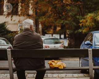 man sitting on bench looking wistful