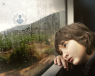 A child looking out a window. 