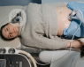 A woman having a transabdominal gynaecological ultrasound.