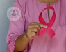 A woman holding the breast cancer pink ribbon.