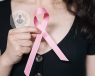 Woman holding the pink breast cancer symbol