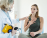 Woman at doctor's office holding her chest