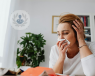 A woman blowing her nose