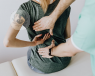 A woman having her back medically examined