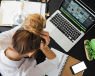 A young woman showing signs of stress at work.